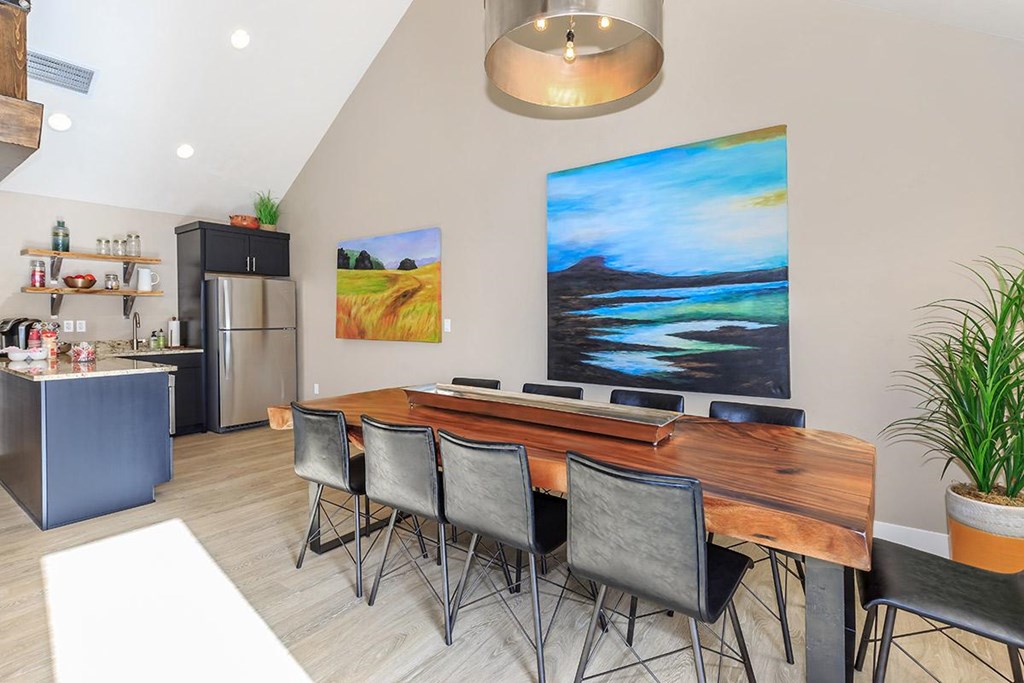 a dining room with a wooden table and chairs